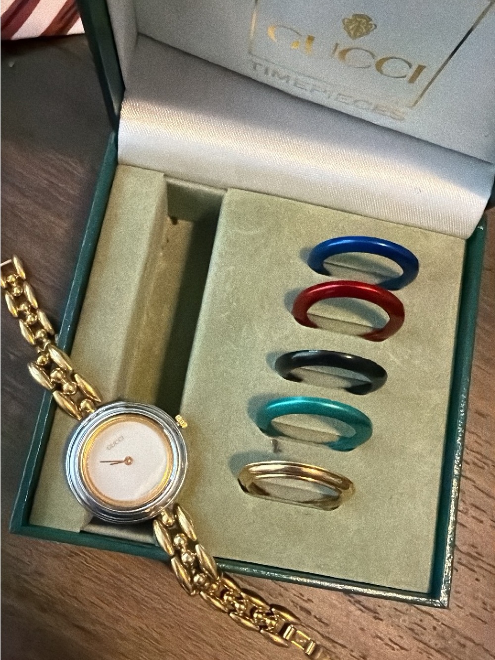 Gucci Gold Bracelet Watch with Blue, Red, Black, Teal, and Gold Bezels